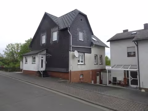 Zwangsversteigerung Einfamilienhaus in Bad Endbach, Bottenhorn – Außenansicht von Südwesten mit dem Eingangsvorbau.