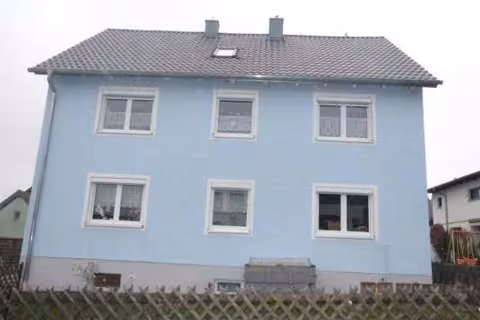 Zwangsversteigerung Mehrfamilienhaus in Kümmersbruck – Wohnhaus Ansicht von Westen mit Vorgarten und Fassade.