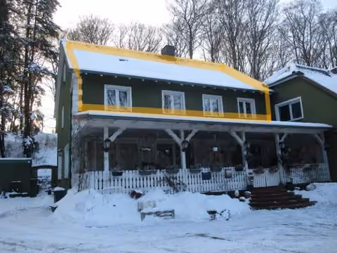 Zwangsversteigerung Eigentumswohnung in Rinteln, Todenmann – Vorderansicht des Mehrfamilienhauses im Winter