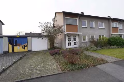 Zwangsversteigerung Doppelhaushälfte in Kamen, Methler – Nordansicht des Wohnhauses mit Straßenfront und Garagenzufahrt.