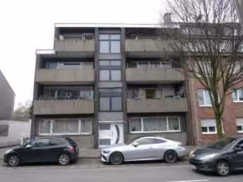 Zwangsversteigerung Eigentumswohnung in Oberhausen, Holten – Straßenansicht des Mehrfamilienhauses Siegesstraße 181 mit Staffelgeschoss und Loggien.