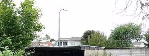 Zwangsversteigerung Zweifamilienhaus in Köln, Pesch – Ansicht des Carports und der Abstellfläche an der Grundstücksgrenze.