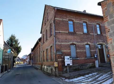 Zwangsversteigerung Einfamilienhaus in Waldeck – Südansicht des ländlichen Wohnhauses mit Saal und hofseitigen Anbauten.