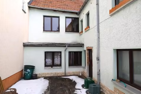 Zwangsversteigerung Einfamilienhaus in Königsee – Rückwärtige Hofseite und Anbau mit Terrassenbereich.