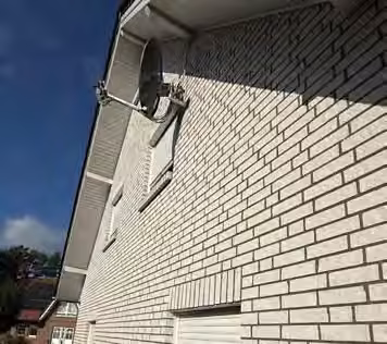 Zwangsversteigerung Zweifamilienhaus in Fürstenau – Frontansicht des Zweifamilienhauses mit Zufahrt und Garage aus Richtung Südwesten.