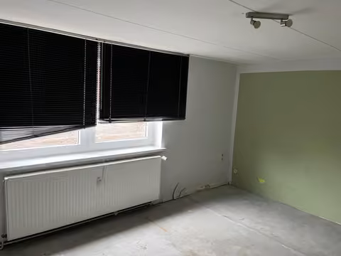 Zwangsversteigerung Einfamilienhaus in Remlingen – Exemplarisches Wohnzimmer mit Laminatboden in Wohnung 1.
