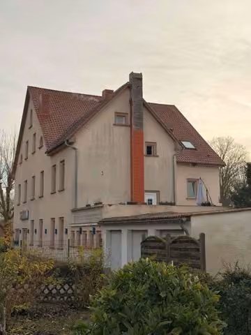 Zwangsversteigerung Wohn-/Geschäftshaus in Altrip – Rückansicht des Gebäudes mit Anbauten und Gartenbereich.