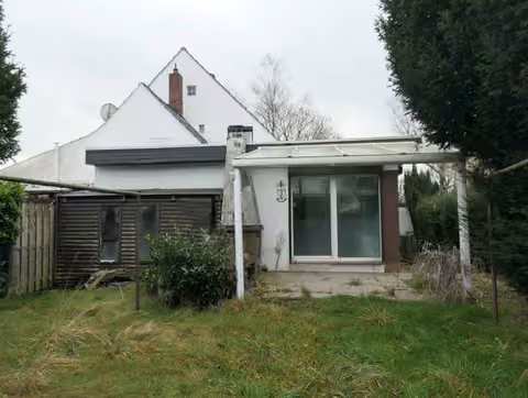 Zwangsversteigerung Doppelhaushälfte in Bremen, Blumenthal – Rückansicht des Objekts mit Anbau, Garten und Terrassenüberdachung.