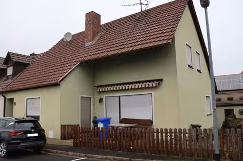 Zwangsversteigerung Einfamilienhaus in Wiesentheid, Geesdorf – Vorderansicht des Einfamilienhauses mit Giebel und Zufahrtsbereich.