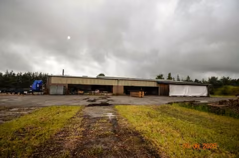 Zwangsversteigerung Grundstück in Lychen, Retzow – Zufahrt und befestigte Freifläche des Gewerbegrundstücks.