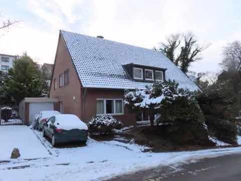 Zwangsversteigerung Einfamilienhaus in Würselen, Bardenberg – Frontansicht des Einfamilienhauses mit winterlicher Straßenansicht und Garagenzufahrt.