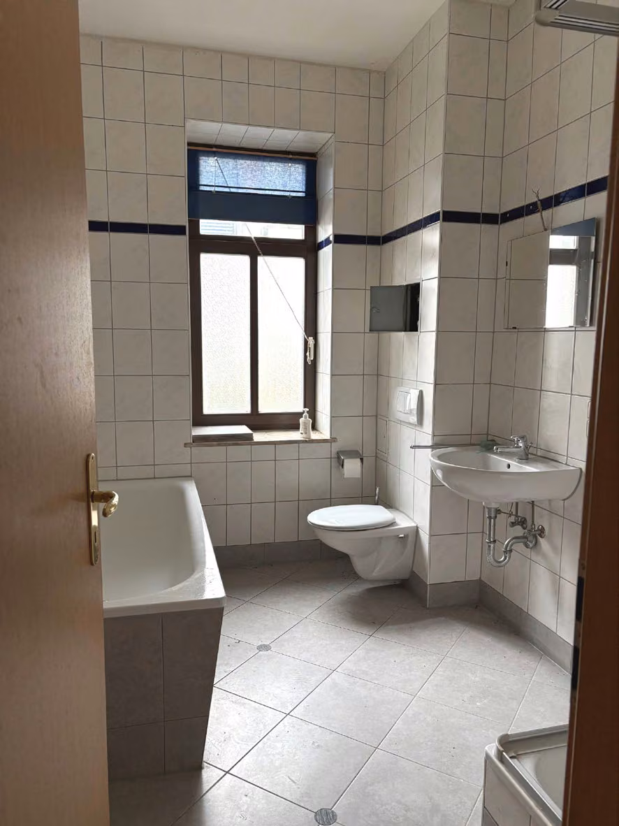 Zwangsversteigerung Eigentumswohnung in Chemnitz, Hilbersdorf – Tageslichtbadezimmer mit Fenster, Badewanne, Dusche und Sanitärausstattung.