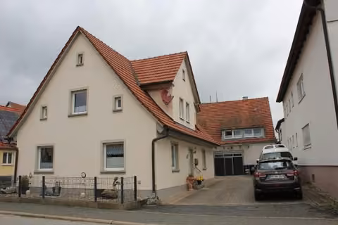 Zwangsversteigerung Einfamilienhaus in Ebermannstadt, Breitenbach – Straßenansicht des Vorderhauses mit Giebelseite und Hofeinfahrt.