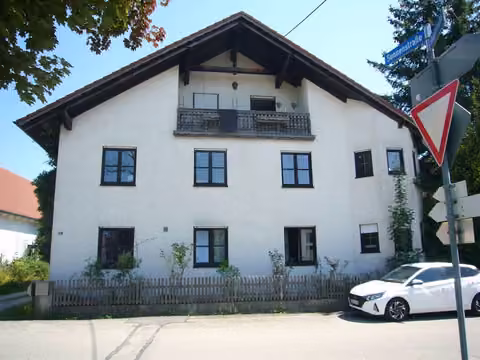 Zwangsversteigerung Mehrfamilienhaus in Prittriching – Frontalansicht des freistehenden Mehrfamilienhauses von der Hauptstraße.
