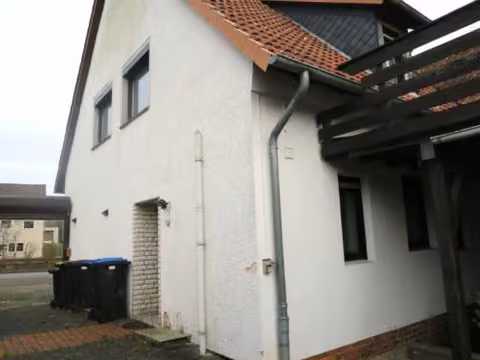 Zwangsversteigerung Mehrfamilienhaus in Walsrode, Benefeld – Wohnhaus mit Carport und Dachterrassentreppe von Süd-Westen.