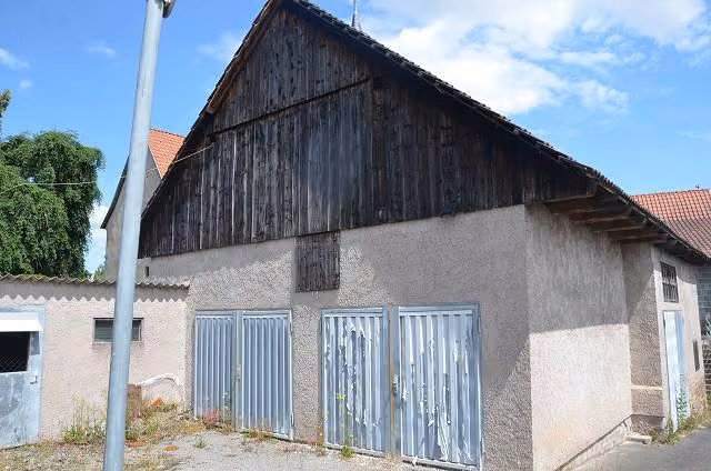 Zwangsversteigerung Zweifamilienhaus in Grabfeld, Wölfershausen – Rückansicht des Wohnhauses und des angrenzenden Gartengrundstücks.