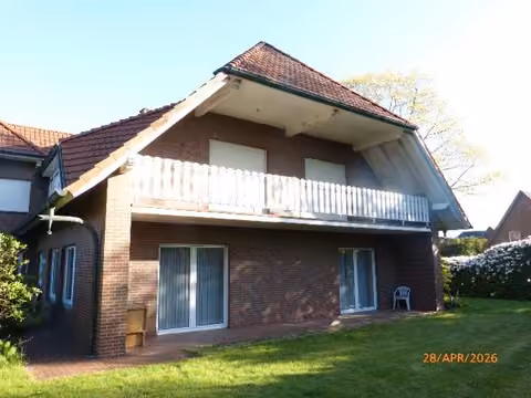 Zwangsversteigerung Einfamilienhaus in Dinklage – Südöstlicher Giebel des Wohnhauses mit Rasenfläche.