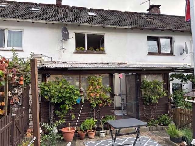 Zwangsversteigerung Reihenhaus in Varel – Gartenseitige Fassade des Reihenmittelhauses mit Terrassenbereich.