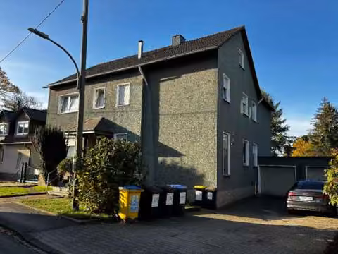 Zwangsversteigerung Zweifamilienhaus in Dortmund, Sölde – Ansicht des Gebäudes von Nordosten mit Garagenzufahrt