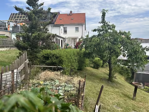 Zwangsversteigerung Einfamilienhaus in Hainichen – Gebäuderückansicht von Süden mit Blick über die genutzte Gartenfläche.