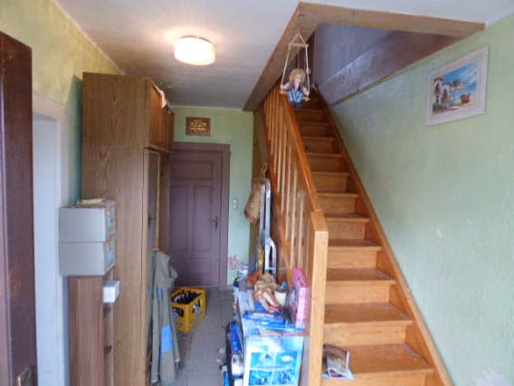 Zwangsversteigerung Einfamilienhaus in Teunz, Weiherhäusl – Eingangsflur im Erdgeschoss mit Holztreppe zum Dachgeschoss.