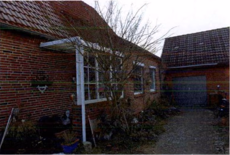 Zwangsversteigerung Einfamilienhaus in Kiebitzreihe – Hauseingangsbereich und Zufahrt zur Garage.