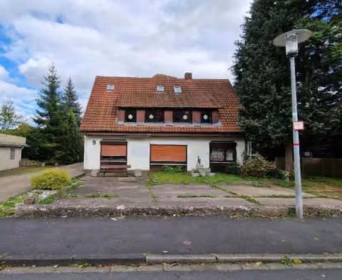 Zwangsversteigerung Stellplatz/Garage in Bad Sooden-Allendorf – Straßenansicht des Anwesens von Südwesten mit Vorgarten und Hauptgiebel.