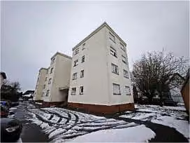 Zwangsversteigerung Eigentumswohnung in Bruchköbel – Gebäudeansicht von Nordwesten mit Fassade und Vorgartenbereich.