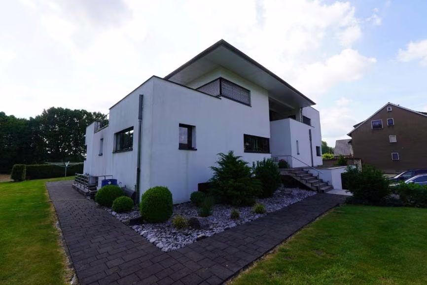 Zwangsversteigerung Zweifamilienhaus in Bergkamen, Overberge – Nordwestansicht des Wohnhauses mit Außenanlagen und Zugangsweg.