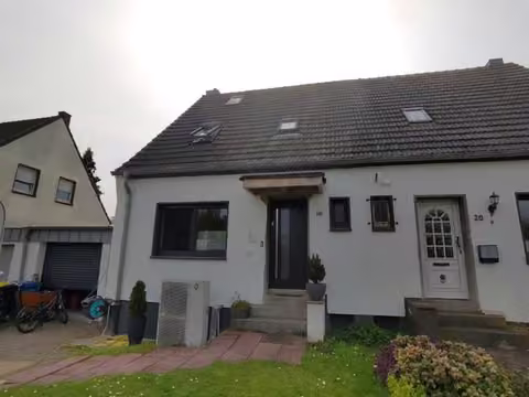 Zwangsversteigerung Doppelhaushälfte in Willich, Schiefbahn – Straßenseitige Ansicht der Doppelhaushälfte mit Hauseingang und Vorgarten
